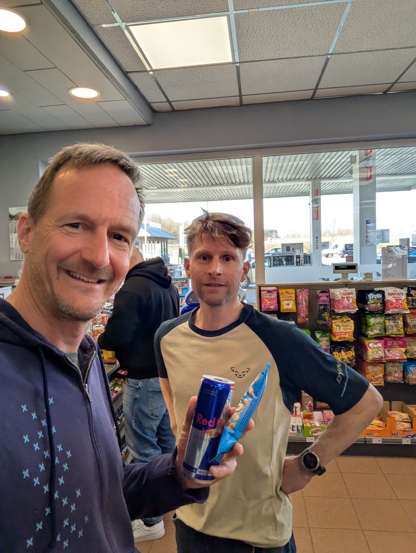 Greg and a friend at a petrol station with a Red Bull